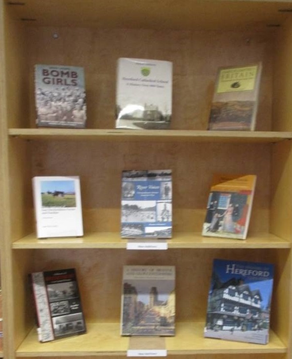 Books displayed on shelves in the Herefordshire Archives