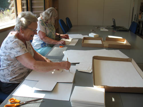 Preparing glassplates for packing at Herefordshire Archives and Record Centre